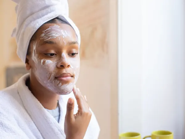 Woman applying face cream in her morning routine